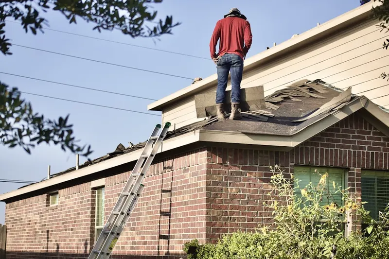 Professional roofer working on a residential roof in Country Home Heights
